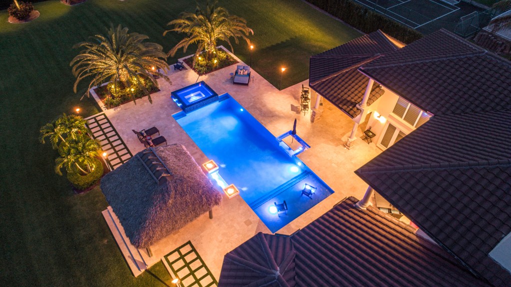 Night Pool with Glowing Fire Features by Van Kirk Pools - Van Kirk & Sons Pools & Spas Custom Lighting, custom lighting for luxury pool, van kirk & sons pools and spas