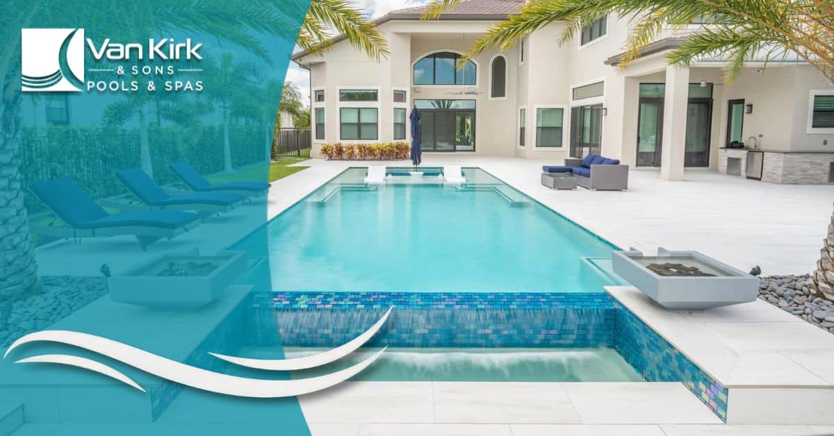 Modern infinity swimming pool with spa spillover and sun shelf overlooking tropical backyard by Van Kirk Pools