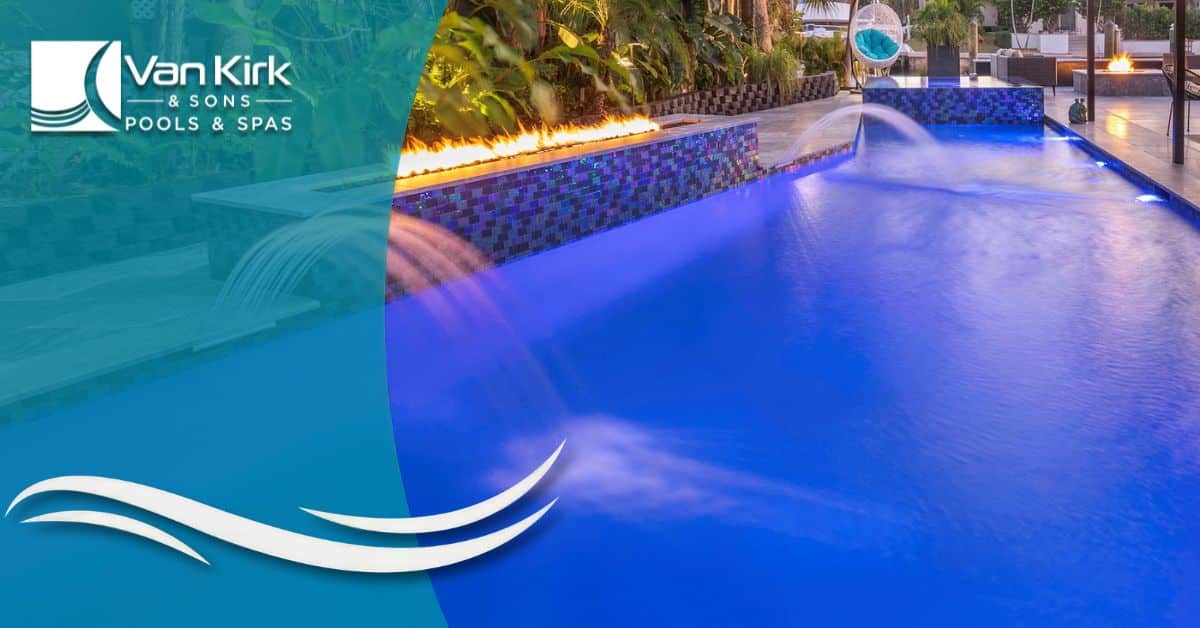 Luxury modern swimming pool with fire and water features surrounded by tropical landscaping by Van Kirk Pools