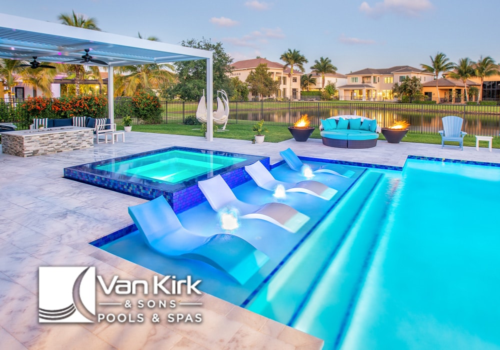 - Van Kirk & Sons Pools & Spas A pool and jacuzzi with chairs and deck jets in Palm Beach County Florida