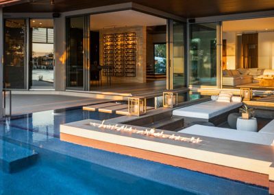 Modern luxury pool with fire feature and sunken seating area designed for functional backyard living.