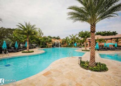 Resort pool area with lounge seating and waterfall feature in Boca Raton.