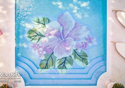 Luxurious swimming pool with floral mosaic design, surrounded by elegant outdoor seating. Van Kirk & Sons Pools & Spas.