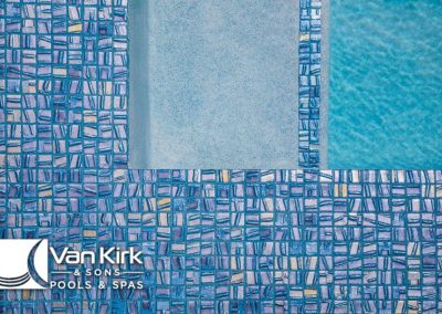 Gradient blue mosaic tiles next to a clear pool by Van Kirk & Sons Pools & Spas.