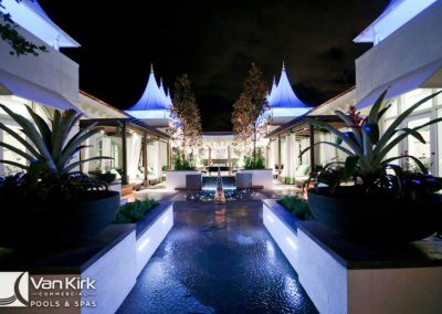 Luxurious night pool view with modern design and ambient lighting at a commercial spa.