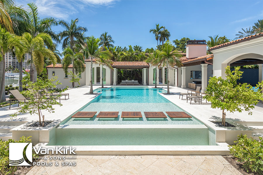 Luxurious outdoor pool surrounded by palm trees and stylish architecture on a sunny day in lotus edge