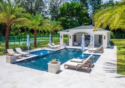 geometric straight-line pool with raised spa, fire bowls, fountains, and cabana.