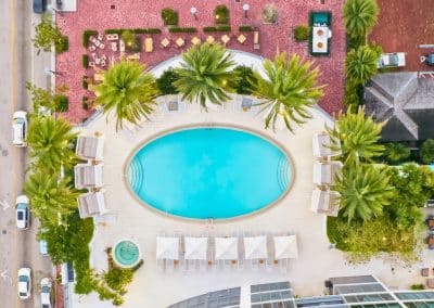 A top-down aerial view showcases the oval resort pool, spa, and cabanas Van Kirk Pools built for Icon Las Olas in Fort Lauderdale.
