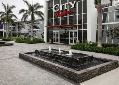 Modern commercial water fountains with stacked stone at the entrance to the City Furniture store in Boca Raton.