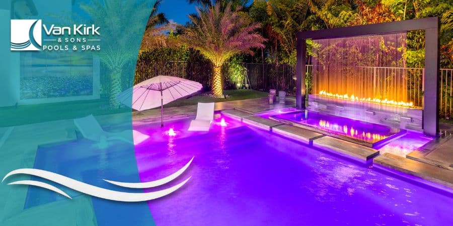 A modern pool at night with vibrant purple LED lighting, an illuminated fire and water wall, and a glowing palm tree.