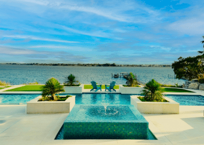 Custom modern geometric pool with a fountain and water features, overlooking the water in Jupiter.