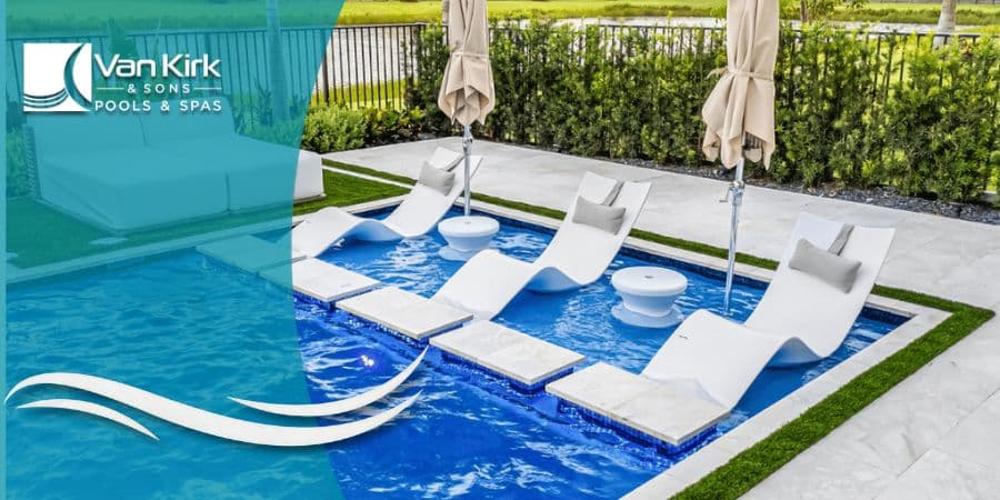 A modern pool sun shelf in Coral Springs with white in-water lounge chairs, stepping stones, and a daybed.