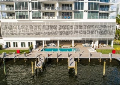 Ground-level Sunset Pool with integrated private docks at Adagio Fort Lauderdale on the Intracoastal Waterway, by Van Kirk & Sons.