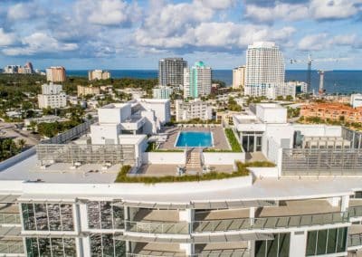 Rectangular rooftop pool with a view of the downtown Fort Lauderdale skyline and ocean at Adagio condo, built by Van Kirk & Sons.