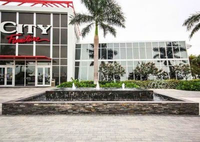 Full view of custom fountain installation at City Furniture Boca Raton by Van Kirk Pools.