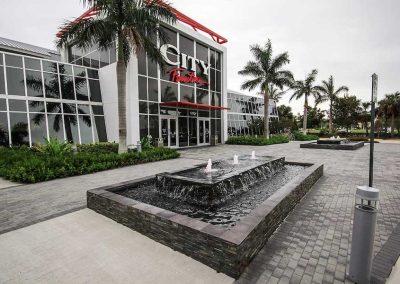 Reflective pool basin with cascading jets at City Furniture Boca Raton