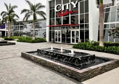 Van Kirk Pools' commercial division built the modern stacked stone water fountains for the City Furniture showroom in Boca Raton.