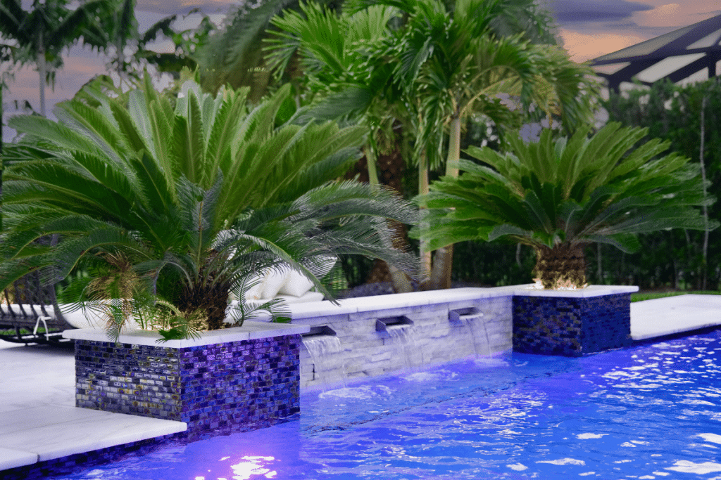 Custom planter waterfalls integrated into a luxury inground pool