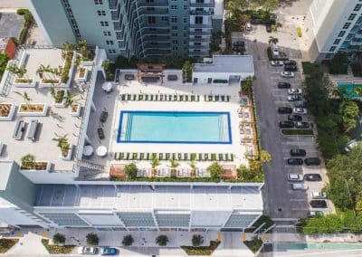 Direct overhead aerial view of the rectangular high-rise apartment amenity pool and surrounding deck in Downtown Fort Lauderdale, by Van Kirk & Sons.