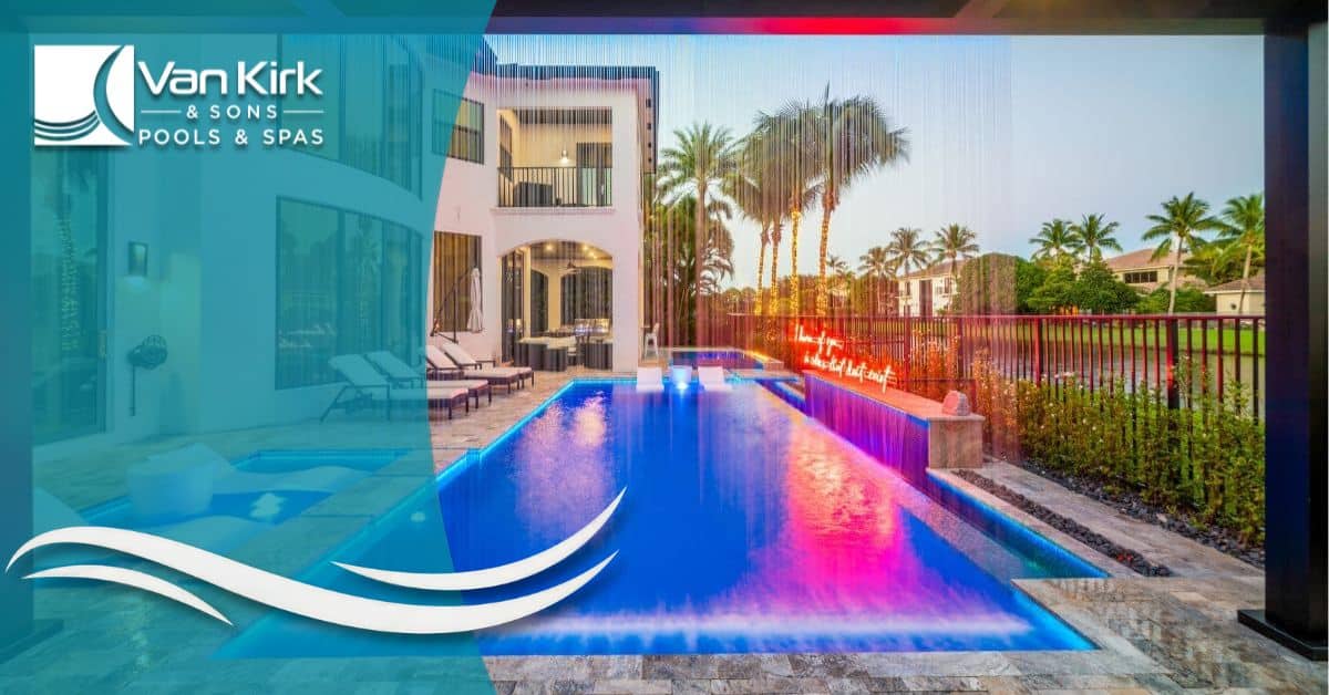 Modern straight-line pool with rain curtain water feature and vibrant LED lighting at sunset