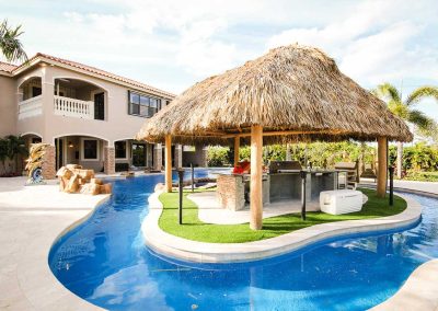 Van Kirk Pools built this lazy river in Loxahatchee with an island tiki hut and outdoor kitchen for The Vanilla Ice Project.
