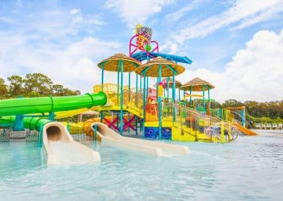 The large water park play structure at Lion Country Safari, built by Van Kirk Pools, featuring multiple slides, a tube slide, and a zero-entry pool.
