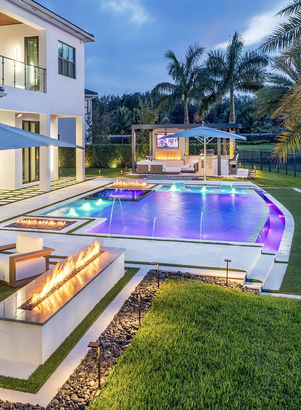Luxurious waterfront acrylic swimming pool with hot tub, palm trees, and yacht, showcasing modern outdoor living in a tropical setting.