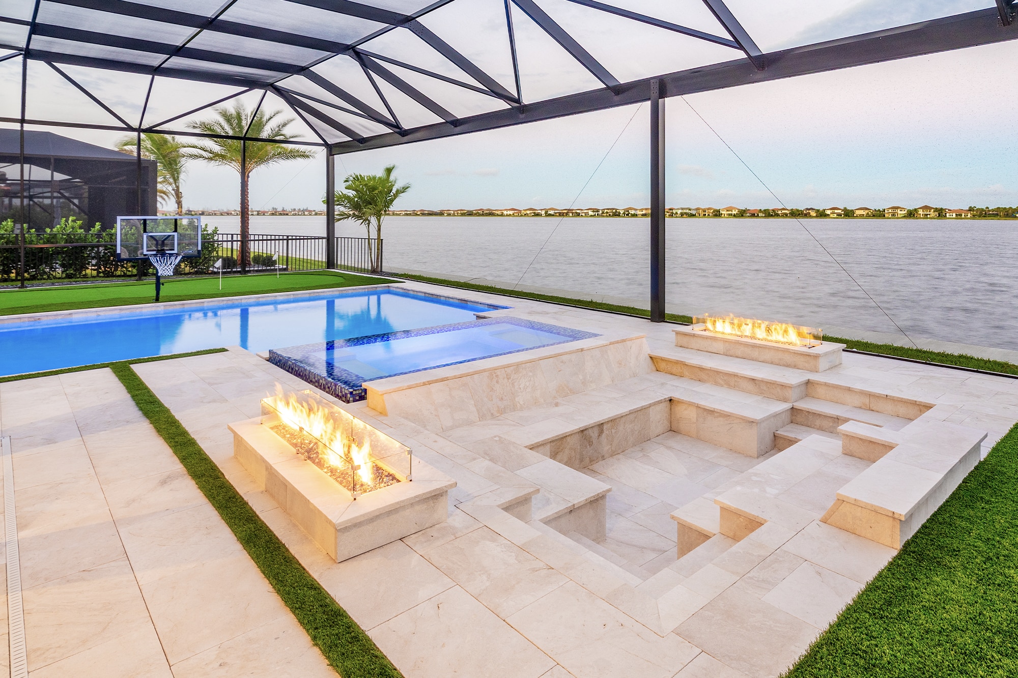 geometric luxury pool with fire features and outdoor entertainment pavilion.